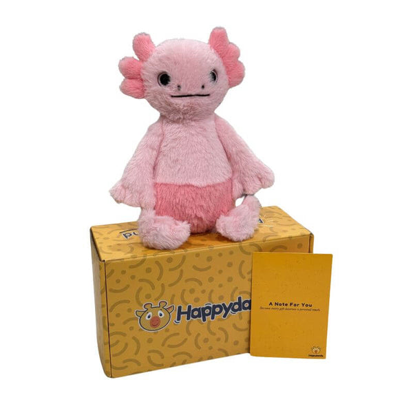 Glow the Axolotl plush sitting on a Happydandis gift box with a handwritten keepsake card