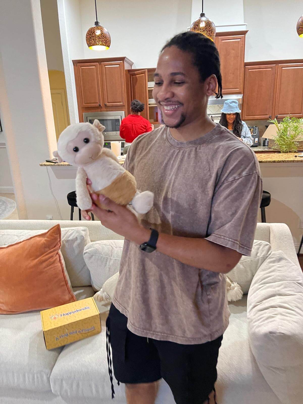 A man holding Zippy the Monkey plush from Happydandis